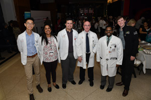 A team of people in white lab smocks assembled by Doctor Mancias.